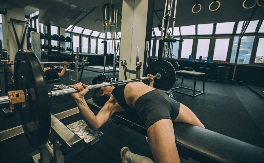 woman bench pressing in the gym