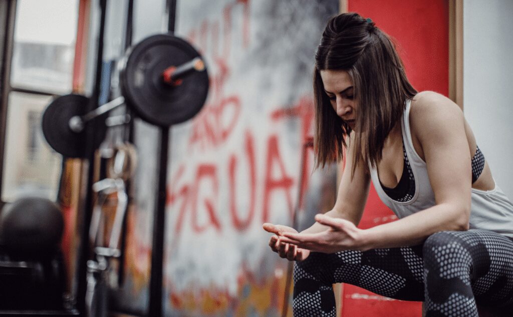 woman resting in between sets of squats