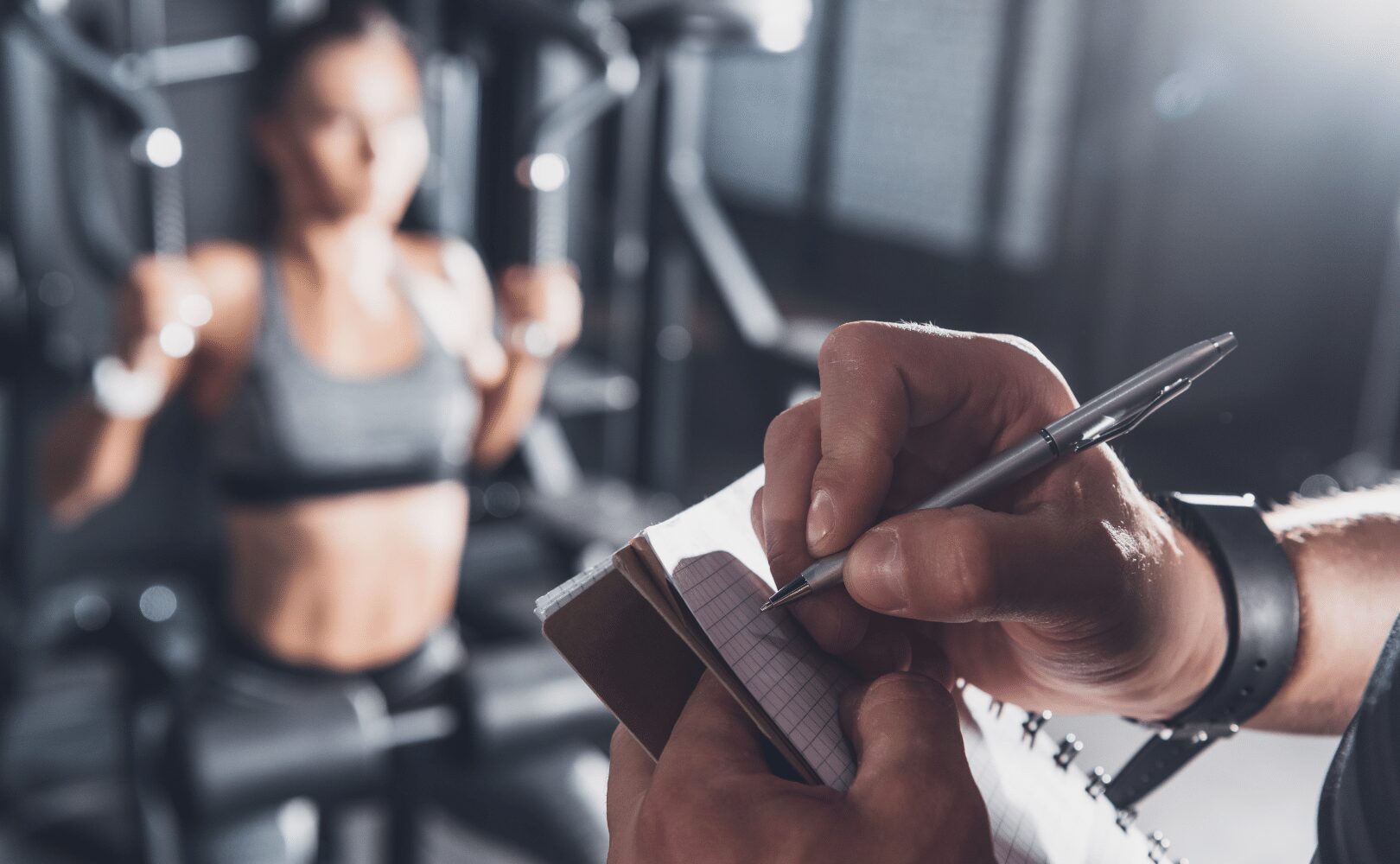 man tracking womens pressing movement in gym
