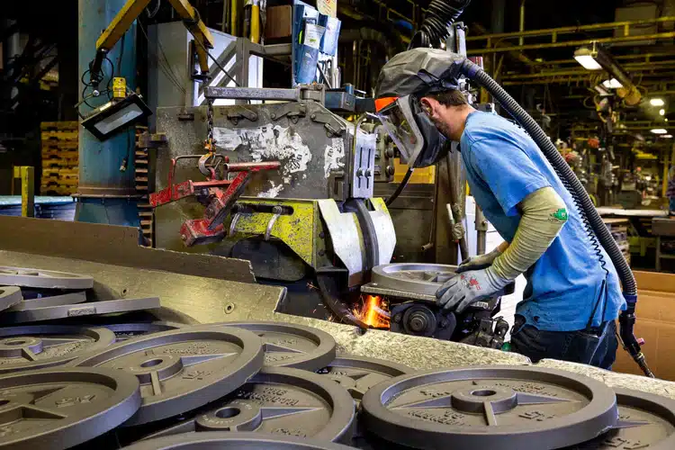 man polishing iron plates
