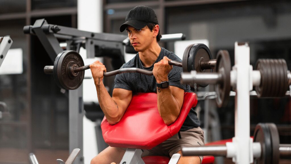 man performing ez bar curl