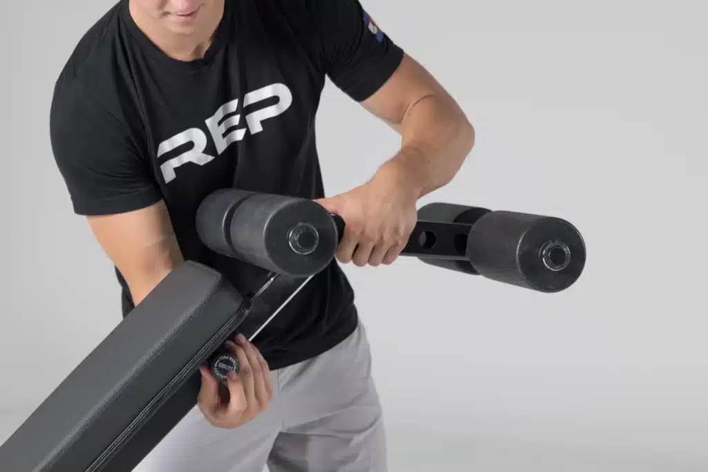 man adjusting pop-pin for leg pad 
