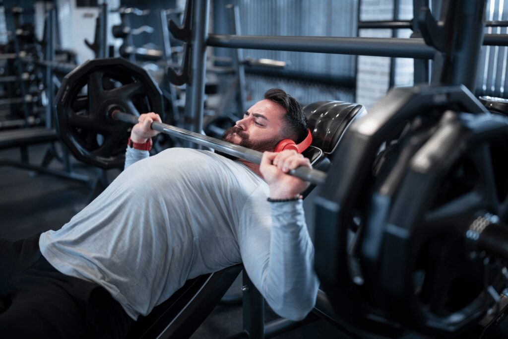 man incline benching over two plates