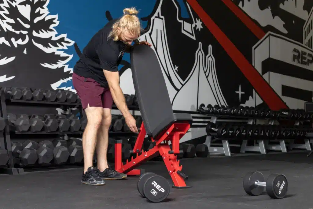 man adjusting the backpad of the ab-3100 adjustable weight bench
