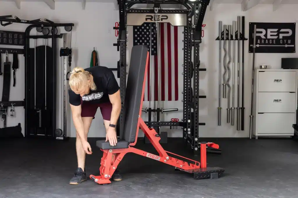 man adjusting adjustable bench