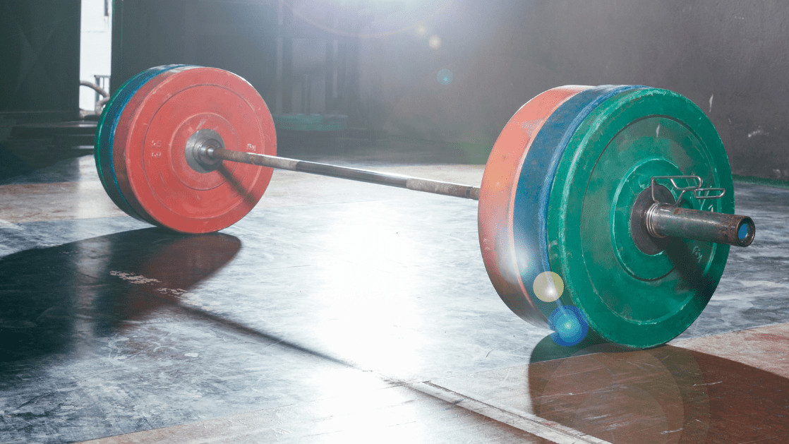 barbell on platform with multi colored bumper plates