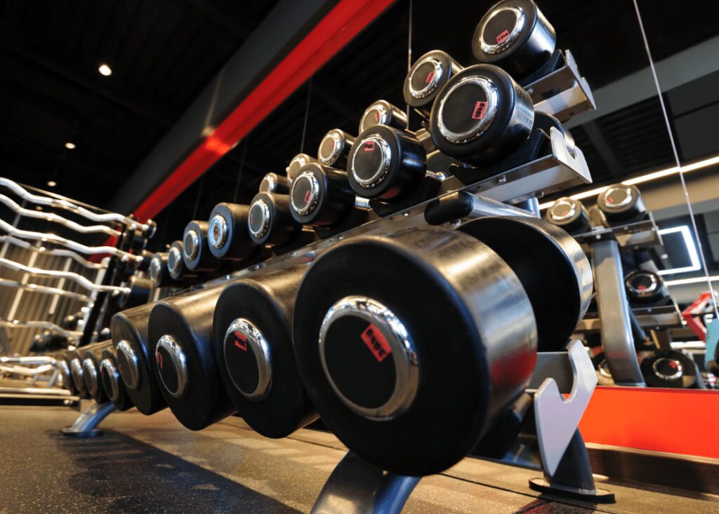 a bunch of dumbbells in a rack