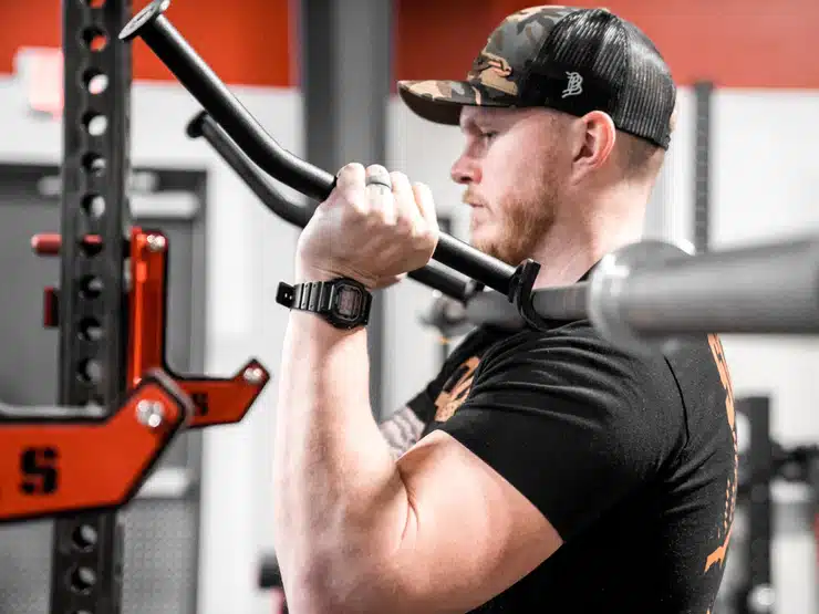 man using the top squat in the front rack position