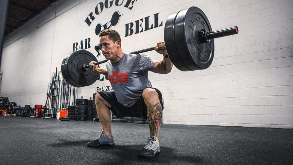 man barbell squatting