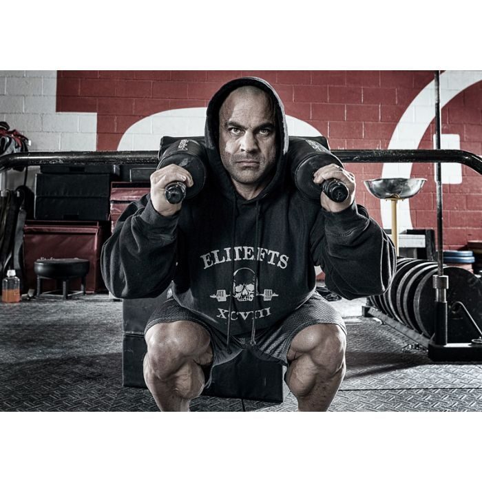 intense man doing a safety bar squat