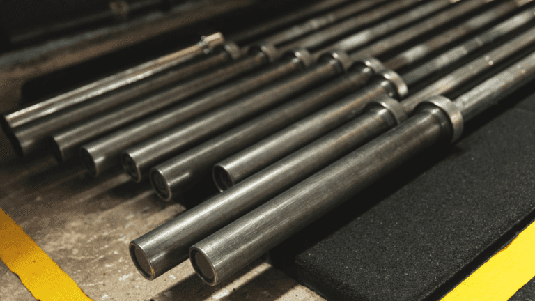 bunch of barbells laying against each other on the ground