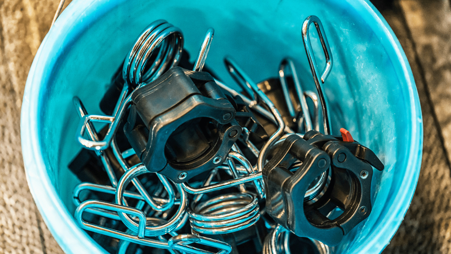 barbell collars in a bucket