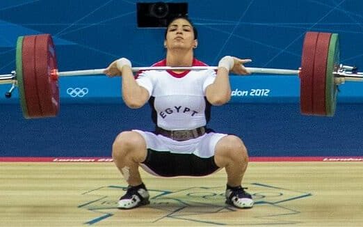 female athlete cleaning with a women's Olympic bar