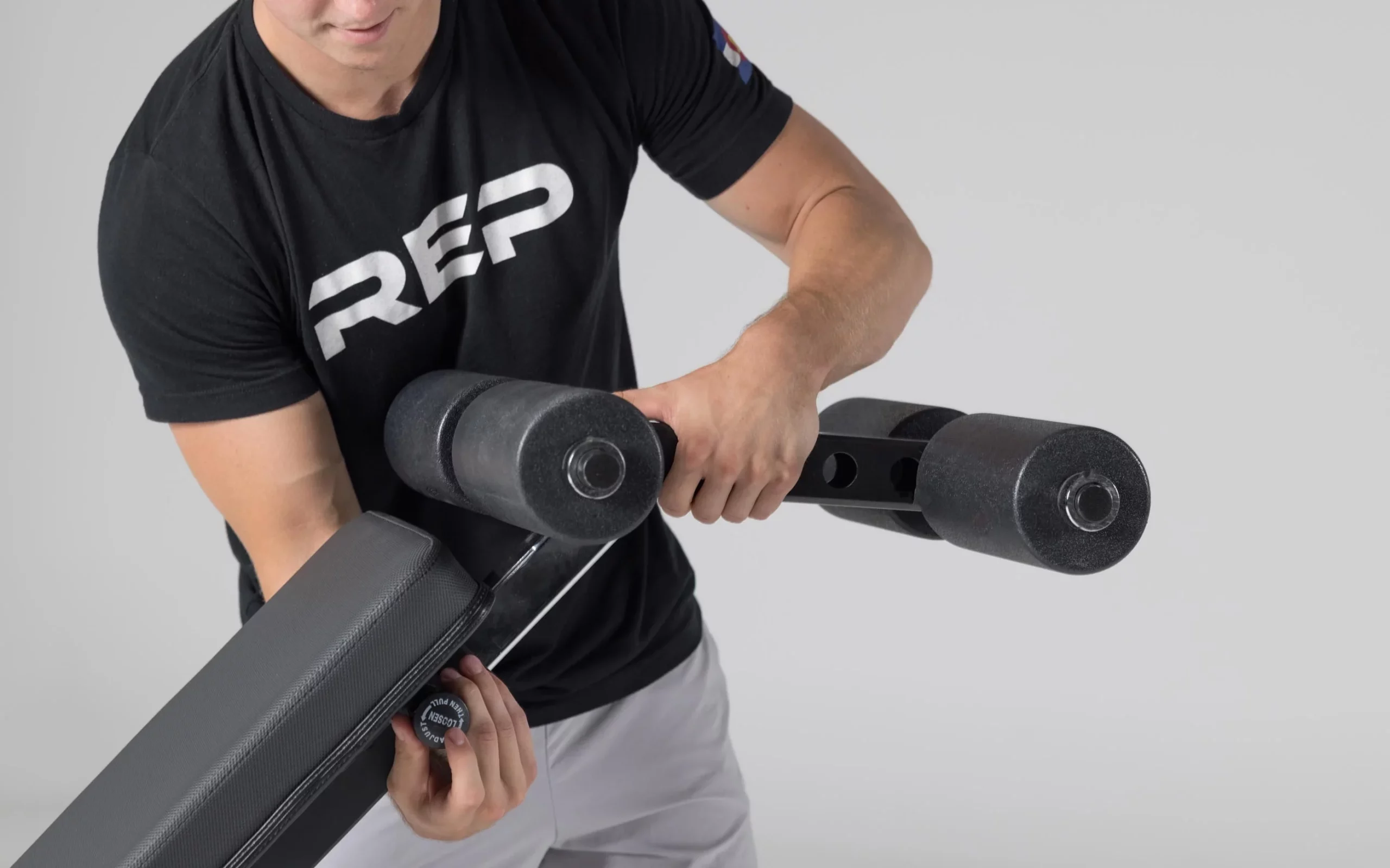 man adjusting decline leg attachment