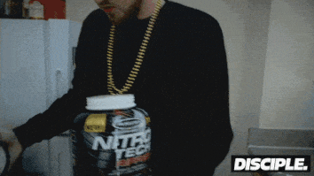 man dumping a bunch of protein into blender