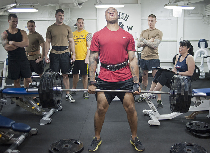 man in red shirt lifting in front of other guys 1