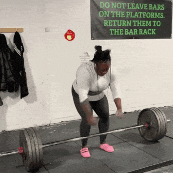 woman deadlifting with a deadlift bar