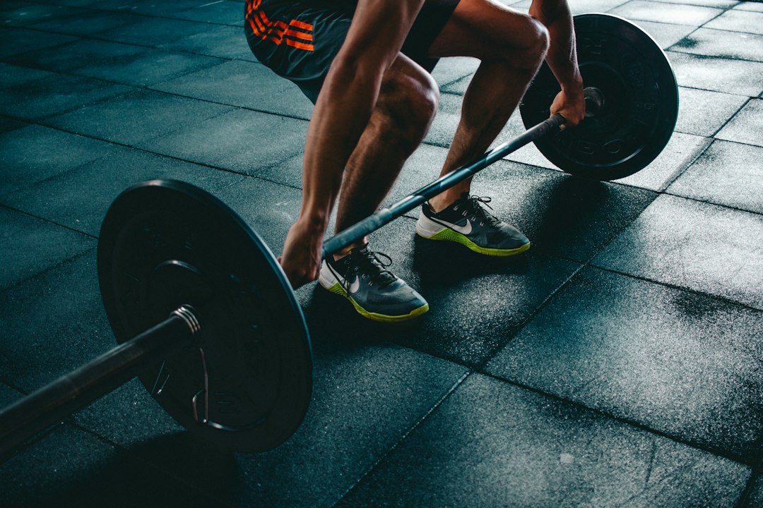 Strength training with a barbell in a gym