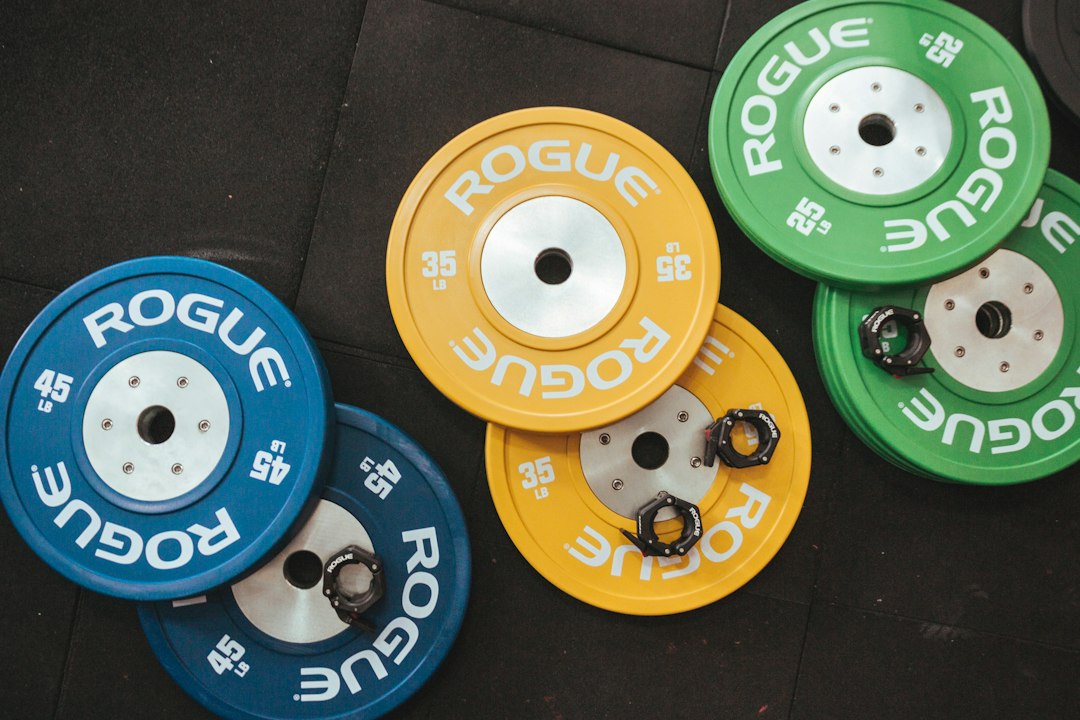 Color bumper plates stacked in a gym